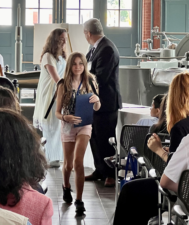 A drawing by a pre-k student of two hearts and a hand