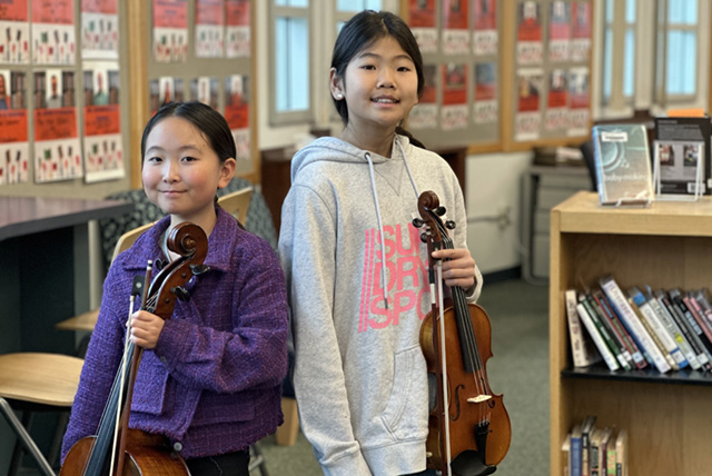 A drawing by a pre-k student of two hearts and a hand