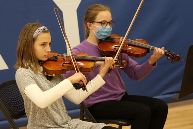 A drawing by a pre-k student of two hearts and a hand